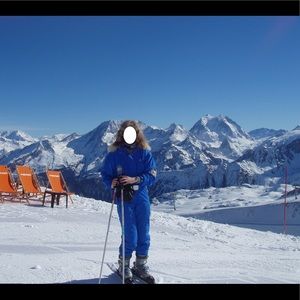 Bogner one piece ski suit with fur collar and metallic belt